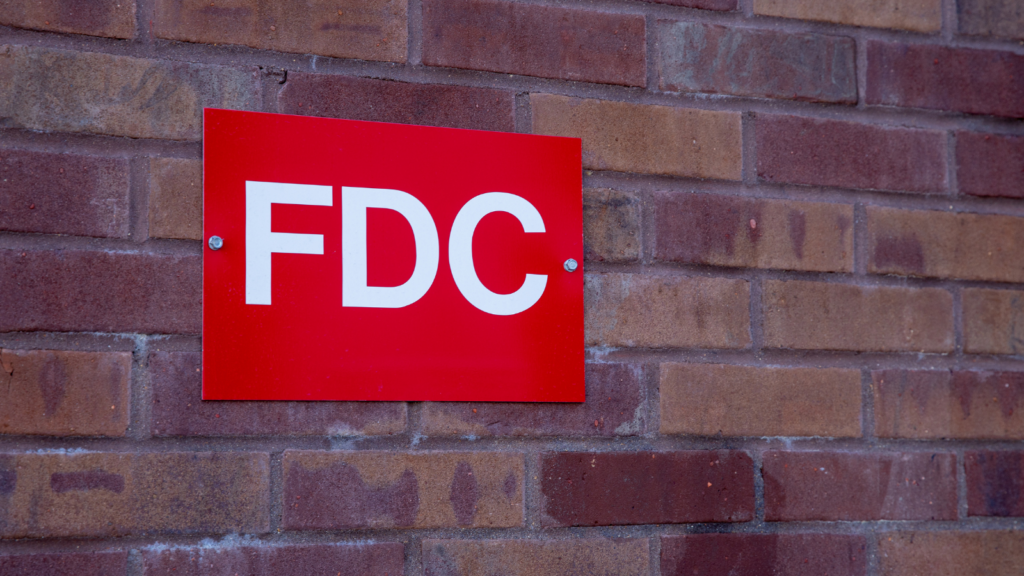 Brick wall with red FDC sign on it.